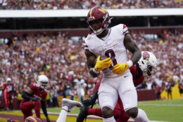 Washington Commanders running back Brian Robinson Jr. (8) scores a touchdown against the Arizona Cardinals during the first half of an NFL preseason football game, Sunday, Sept. 10, 2023, in Landover, Md. (AP Photo/Alex Brandon)