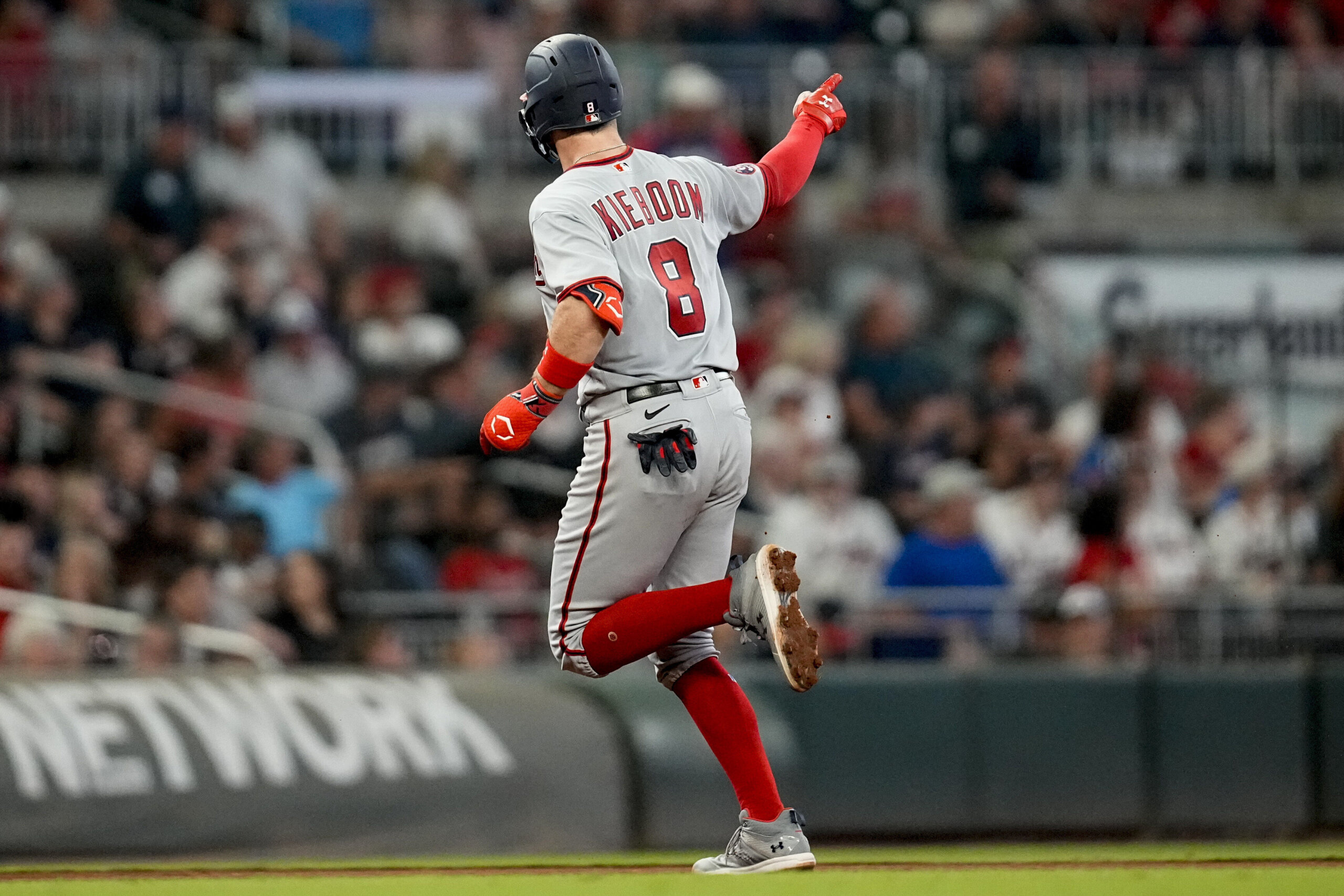 Brian Jordan of the Atlanta Braves celebrates his two-run home run