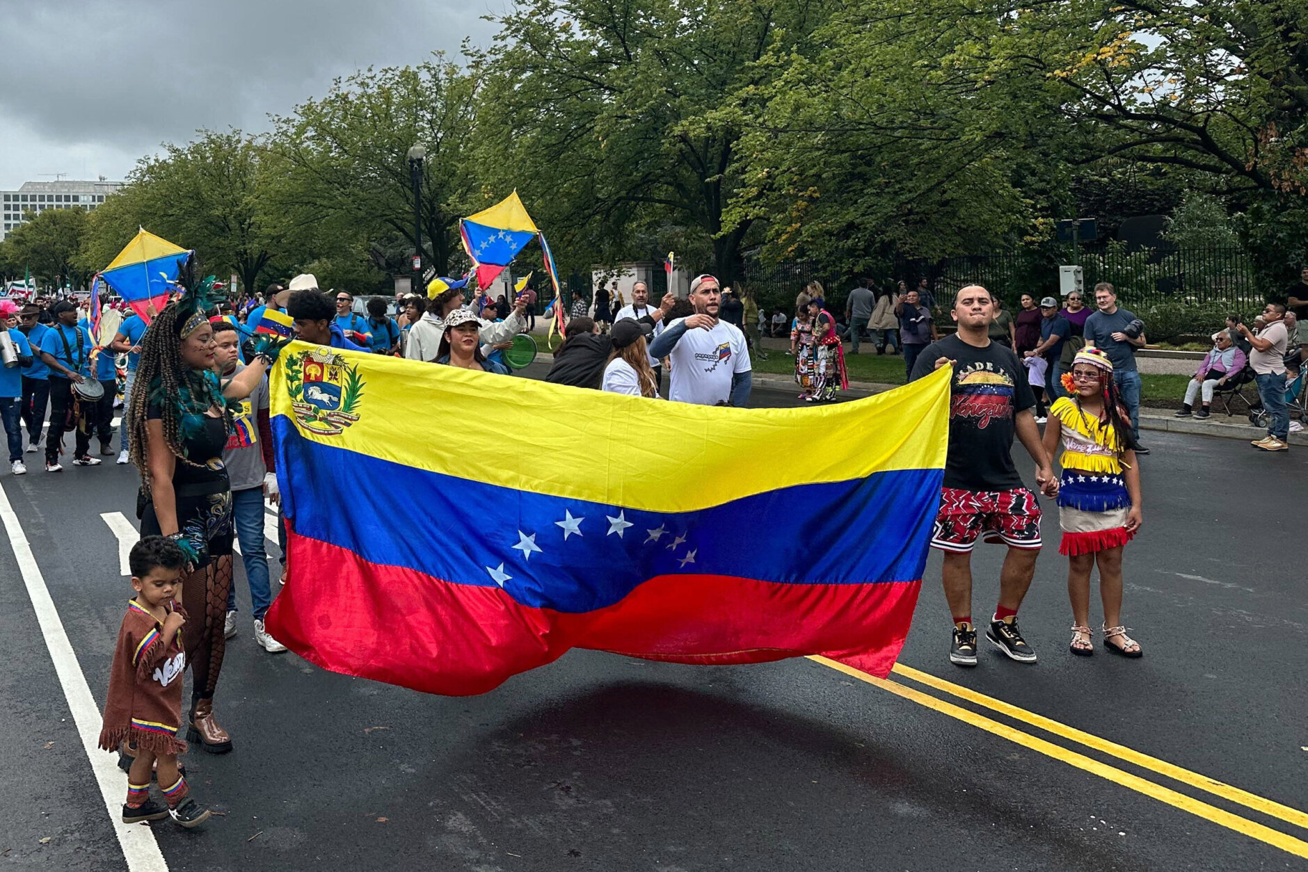 people carry Venezuelan flag in parade