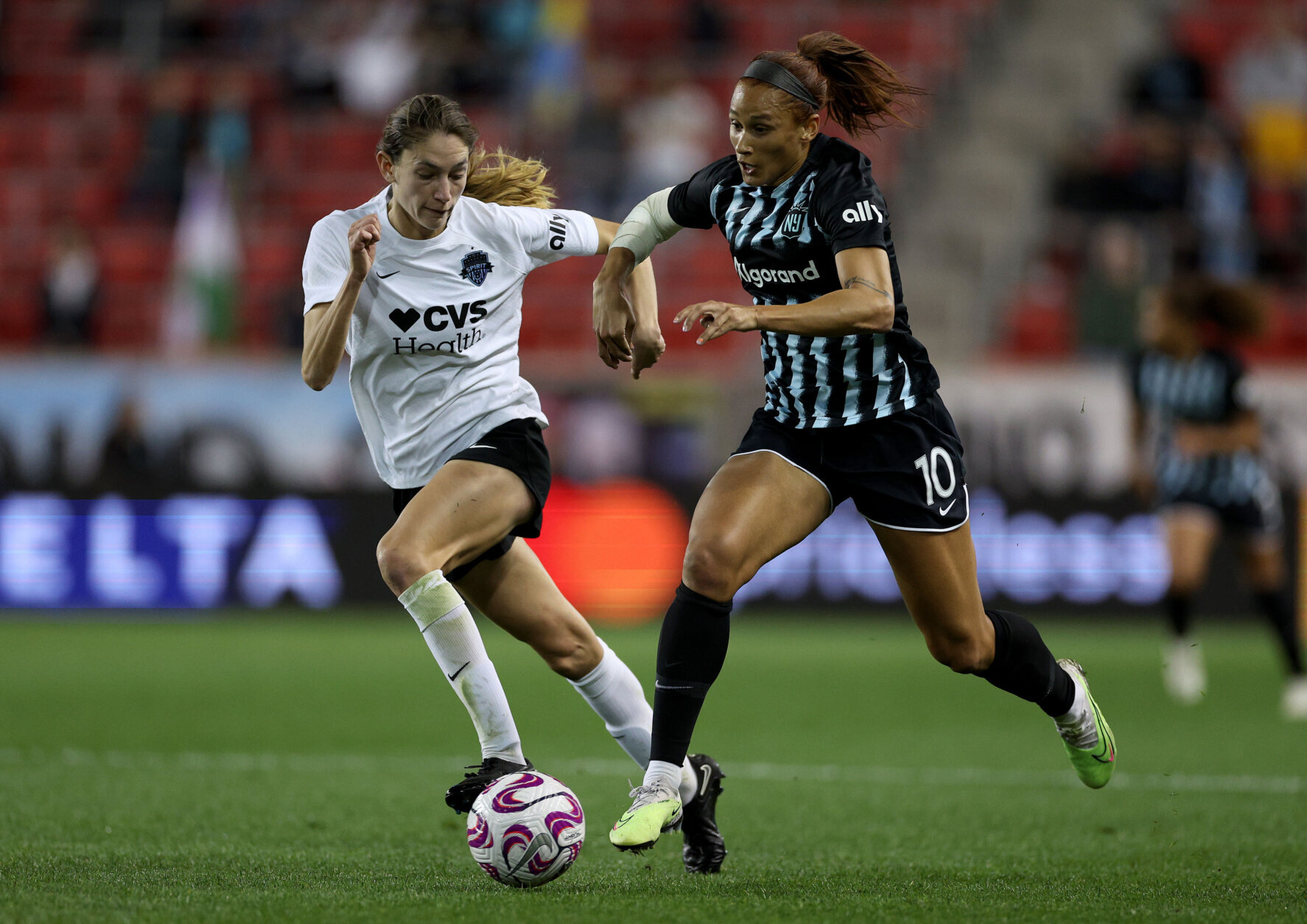 HARRISON, NEW JERSEY - APRIL 19: Paige Metayer #26 of the Washington Spirit and Lynn Williams #10 of the NJ/NY Gotham FC go after the ball during the first half of the 2023 NWSL Challenge Cup match at Red Bull Arena on April 19, 2023 in Harrison, New Jersey. (Photo by Elsa/Getty Images)