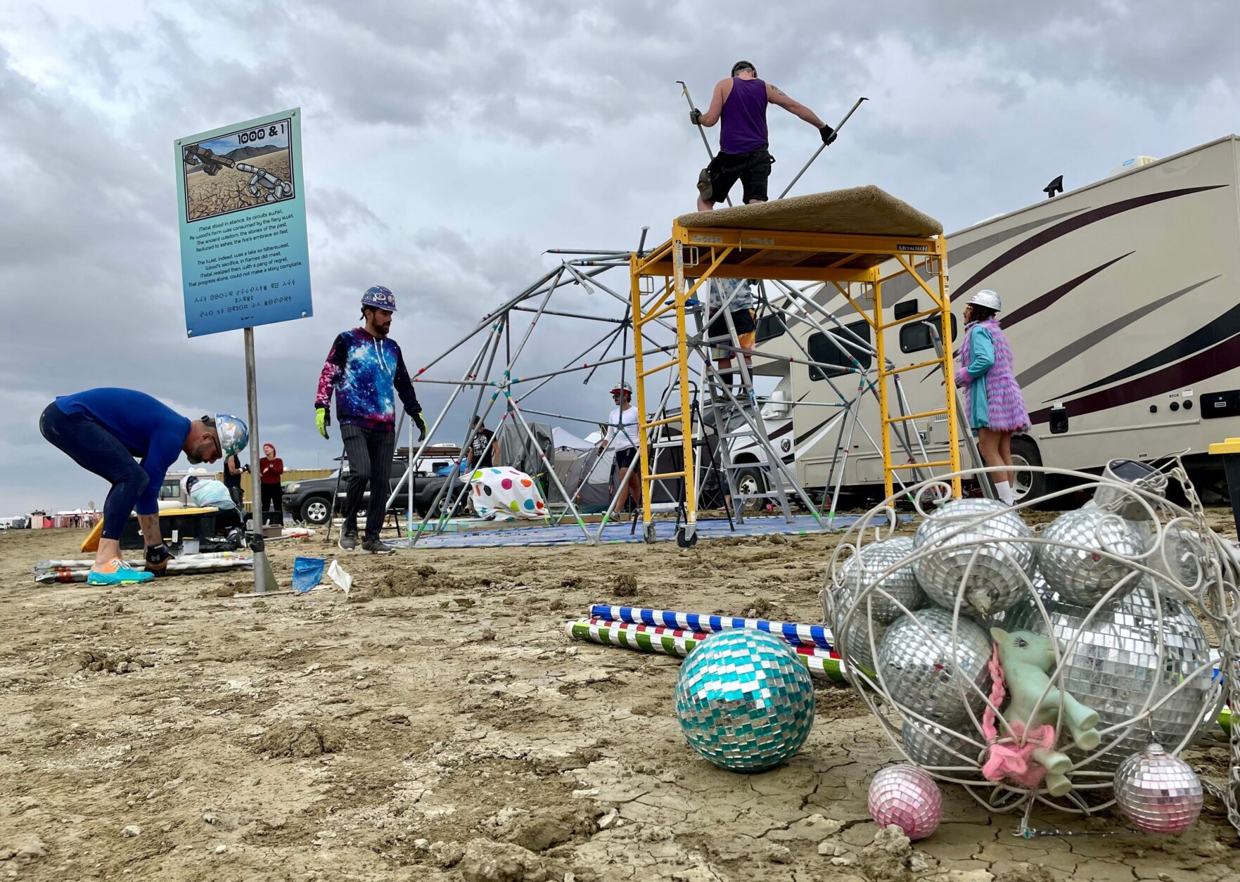 Attendees known as "burners" strike down their Unicorner camp before new rainfalls in a muddy desert plain on September 3, 2023, after heavy rains turned the annual Burning Man festival site in Nevada's Black Rock desert into a mud pit. Tens of thousands of festivalgoers were stranded September 3, in deep mud in the Nevada desert after rain turned the annual Burning Man gathering into a quagmire, with police investigating one death.
Video footage showed costume-wearing "burners" struggling across the wet gray-brown site, some using trash bags as makeshift boots, while many vehicles were stuck in the sludge. (Photo by Julie JAMMOT / AFP) (Photo by JULIE JAMMOT/AFP via Getty Images)