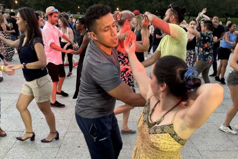 People salsa dancing