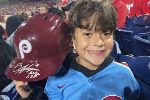 Phillies' Harper flips out on ump, tosses helmet into the stands where it's retrieved by 10-year-old