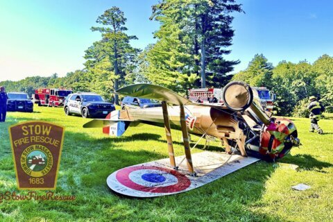 World War I-era plane flips onto roof trying to land near Massachusetts museum; pilot unhurt