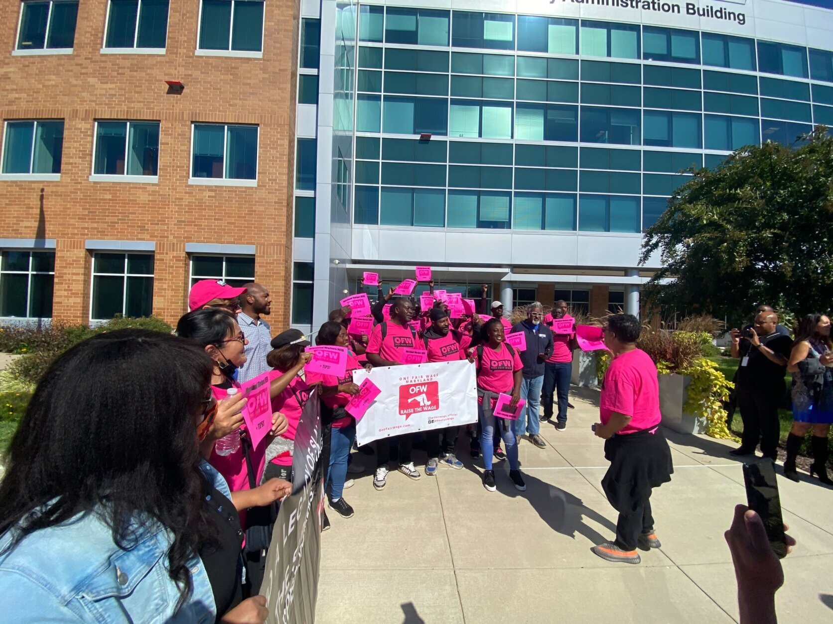 Those in favor of a minimum wage increase for tipped workers in Prince George's County hold a rally on Thursday, wearing pink in solidarity.