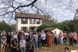 An exuberant crowd of public officials, historians, neighbors, students and others gathered in the backyard of the modest farm house, it’s earliest section built nearly 300 years ago and then walked to the front of the house where the plaques were unveiled. (WTOP/Dick Uliano)