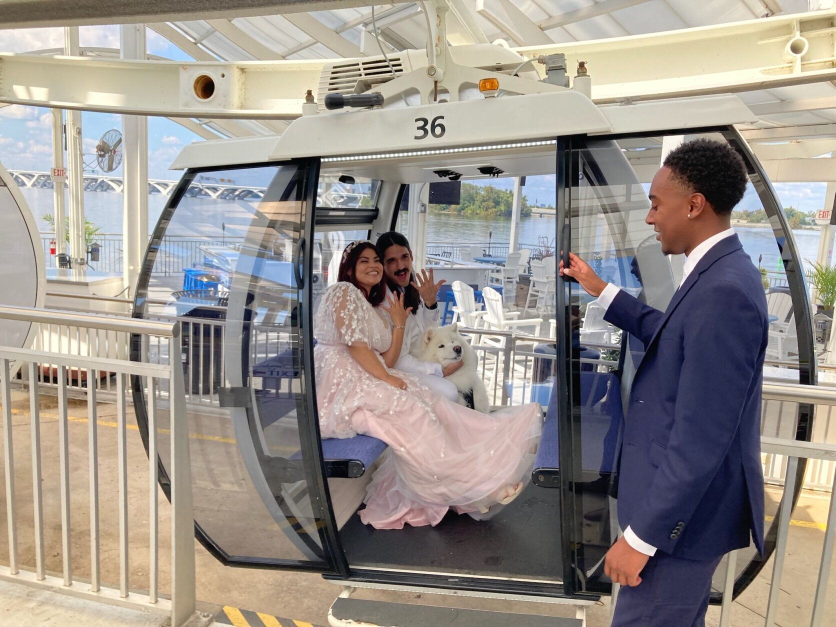 Newlyweds inside Ferris wheel gondola