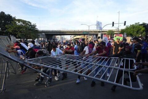 Protesters march in Panama against the contract extension for a huge copper mine