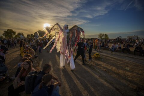 AP PHOTOS: By an eerie lake in Romania, Draculas and skeletons welcome crowds to Halloween fest