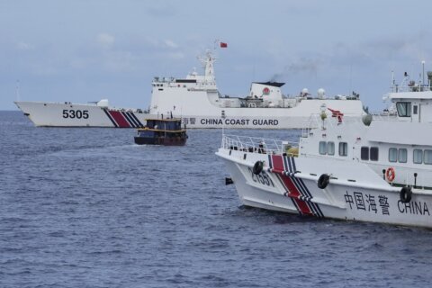Philippine boats breach a Chinese coast guard blockade in a faceoff near a disputed shoal