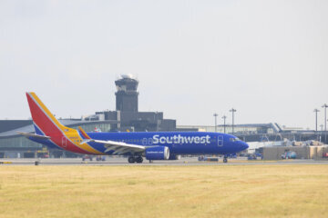 airplane sits on the tarmac near a tower at BWI Marshall airport