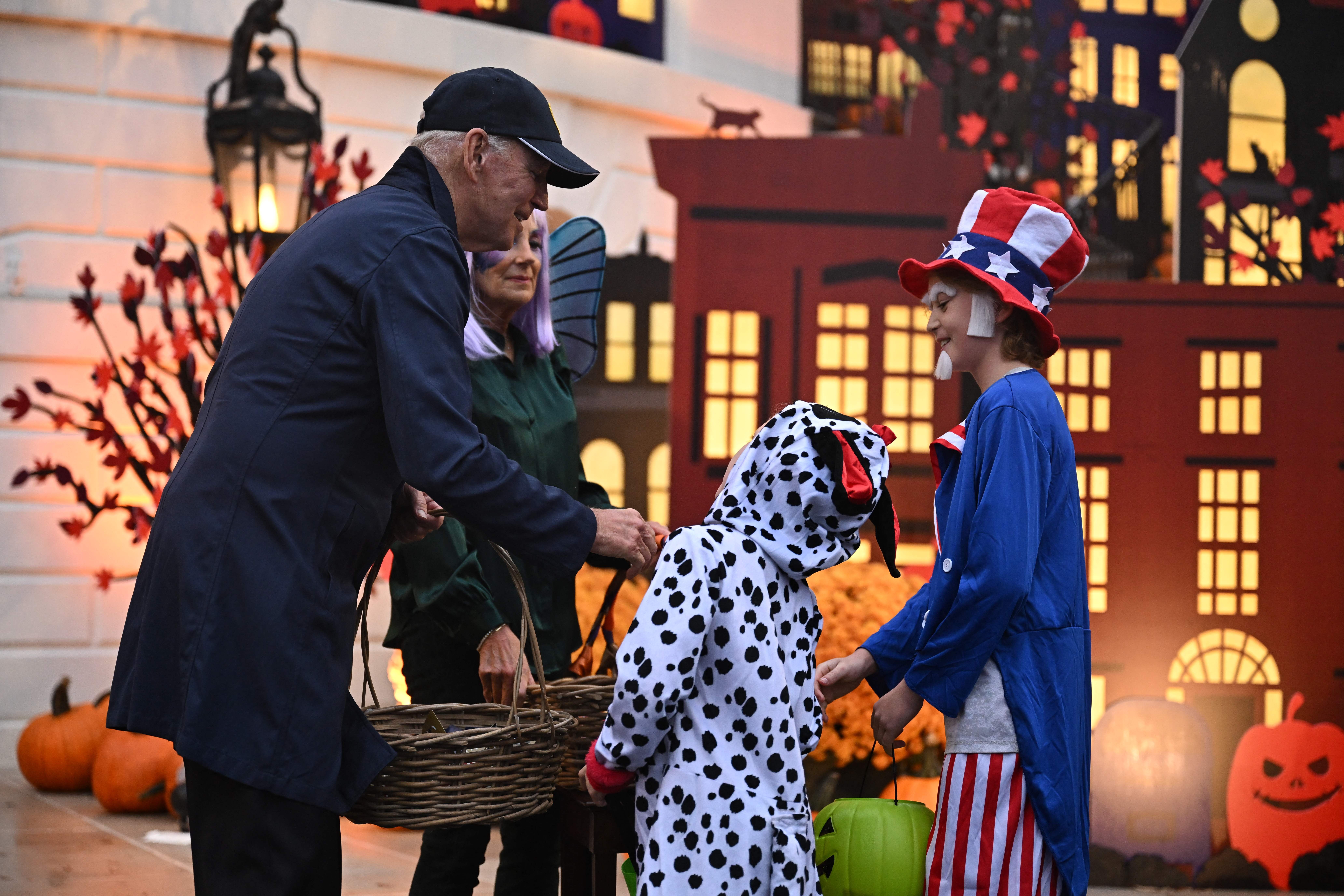 Biden greets children dressed as Uncle Sam and a dalmatian