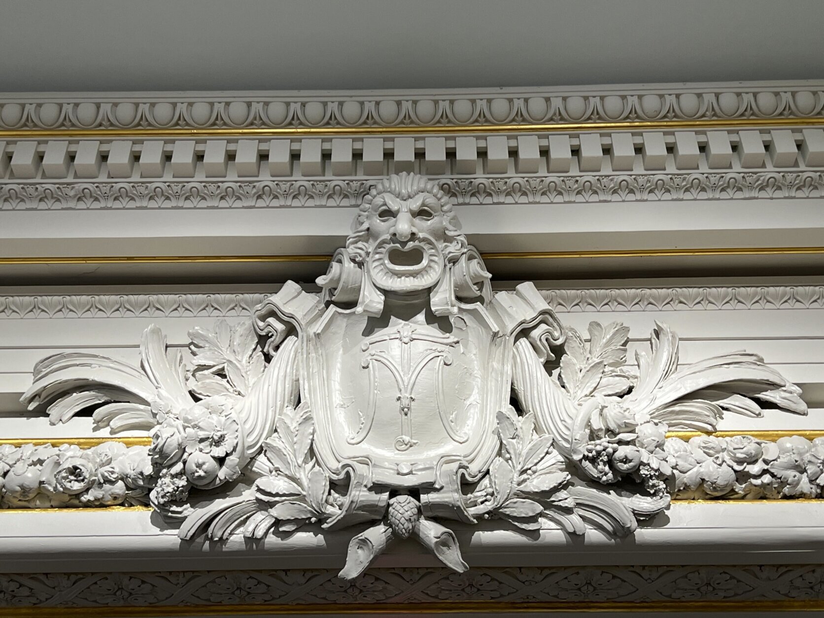 Molding inside the great hall showcases a figure with a shield.