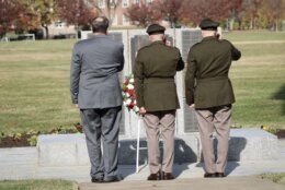 Retired Lt. Col Michael E. Bigelow, Col Joseph Messina and Sgt. Maj. Garth D. Newell salute the the wreath