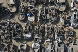 Israeli security forces inspect charred vehicles burned in the bloody Oct. 7 cross-border attack by Hamas militants outside the town of Netivot, southern Israel. The cars were collected and placed in an area near the Gaza border after the attack, in which 1,400 people were killed and some 240 people were taken hostage. (AP Photo/Ariel Schalit)