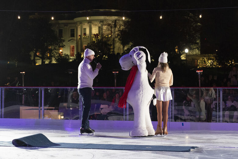 Olympic figure skater Brian Boitano, left, talks with Snoopy and Kim Navarro, Ice Dancer and Skating Director at Snoopy's Home Ice, during the unveiling of the White House Holiday Ice Rink, located at the south panel of the South Lawn of the White House complex, Wednesday, Nov. 29, 2023, in Washington. (AP Photo/Jacquelyn Martin)