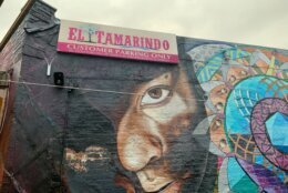 a mural outside of el tamarindo shows a person's face