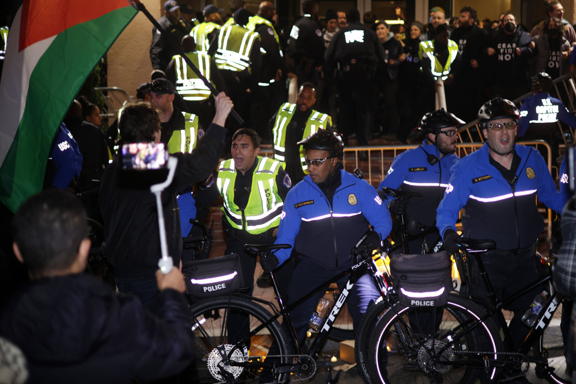 WASHINGTON, DC - NOVEMBER 15: Members of U.S. Capitol Police try set up a perimeter with their bicycles as protesters block the entrance of the headquarters of the Democratic National Committee during a demonstration against the war between Israel and Hamas on November 15, 2023 on Capitol Hill in Washington, DC. Jewish Voice for Peace and If Not Now held a candlelight vigil outside DNC headquarters to call for a ceasefire in the Israel-Hamas war. (Photo by Alex Wong/Getty Images)