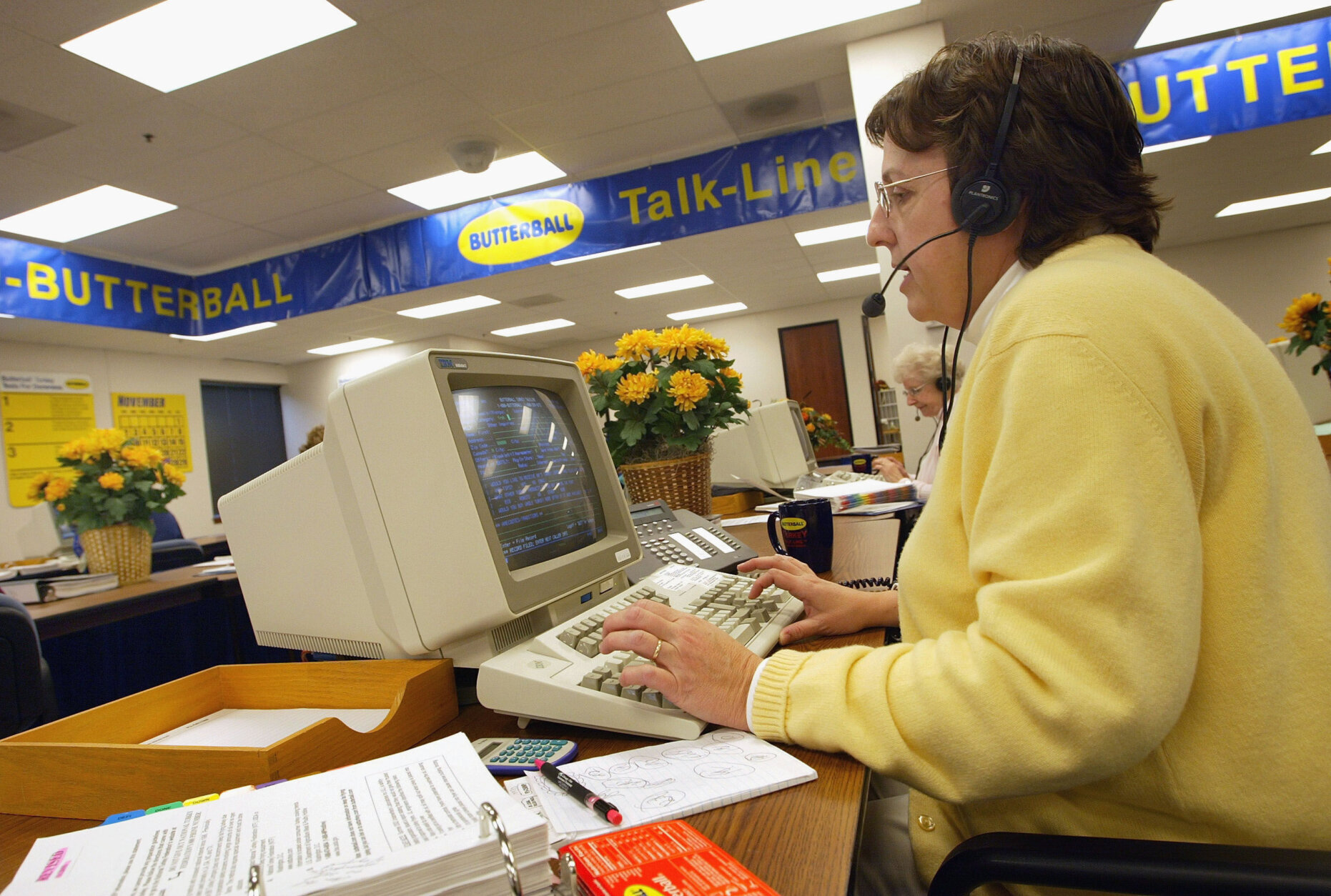 DOWNERS GROVE, IL - NOVEMBER 24: 3-year-veteran Butterball Turkey Talk-Line home economist Jane Schuelke answers questions on her telephone headset at the Butterball Turkey Talk-Line headquarters November 24, 2003 in Downers Grove, Illinois. The Butterball Talk-Line was created to assist everyone from first-time cooks to seasoned chefs with preparing their holiday bird. Originally staffed with six home economists who responded to 11,000 phone calls in its first year alone, today the Talk-Line is staffed with nearly 50 home economists and nutritionists who respond to more than 100,000 questions each November and December. ConAgra Foods opened the Butterball Turkey Talk-Line in 1981. (Photo by Tim Boyle/Getty Images)
