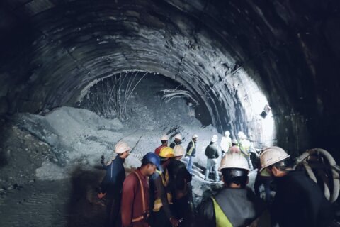 Rescuers dig to reach 40 workers trapped in collapsed road tunnel in north India