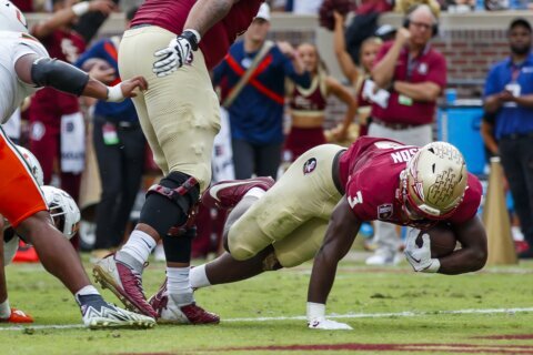 No. 4 Florida State beats Miami 27-20 to win its 16th straight and remain on track for CFP