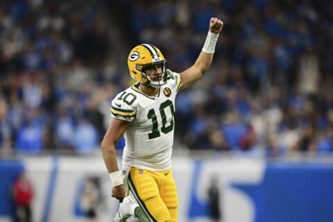 Love ties career high with 3 TD passes, leads Packers to 29-22 win over NFC North-leading Lions