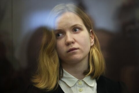 Russian woman goes on trial in a cafe bombing that killed a prominent military blogger