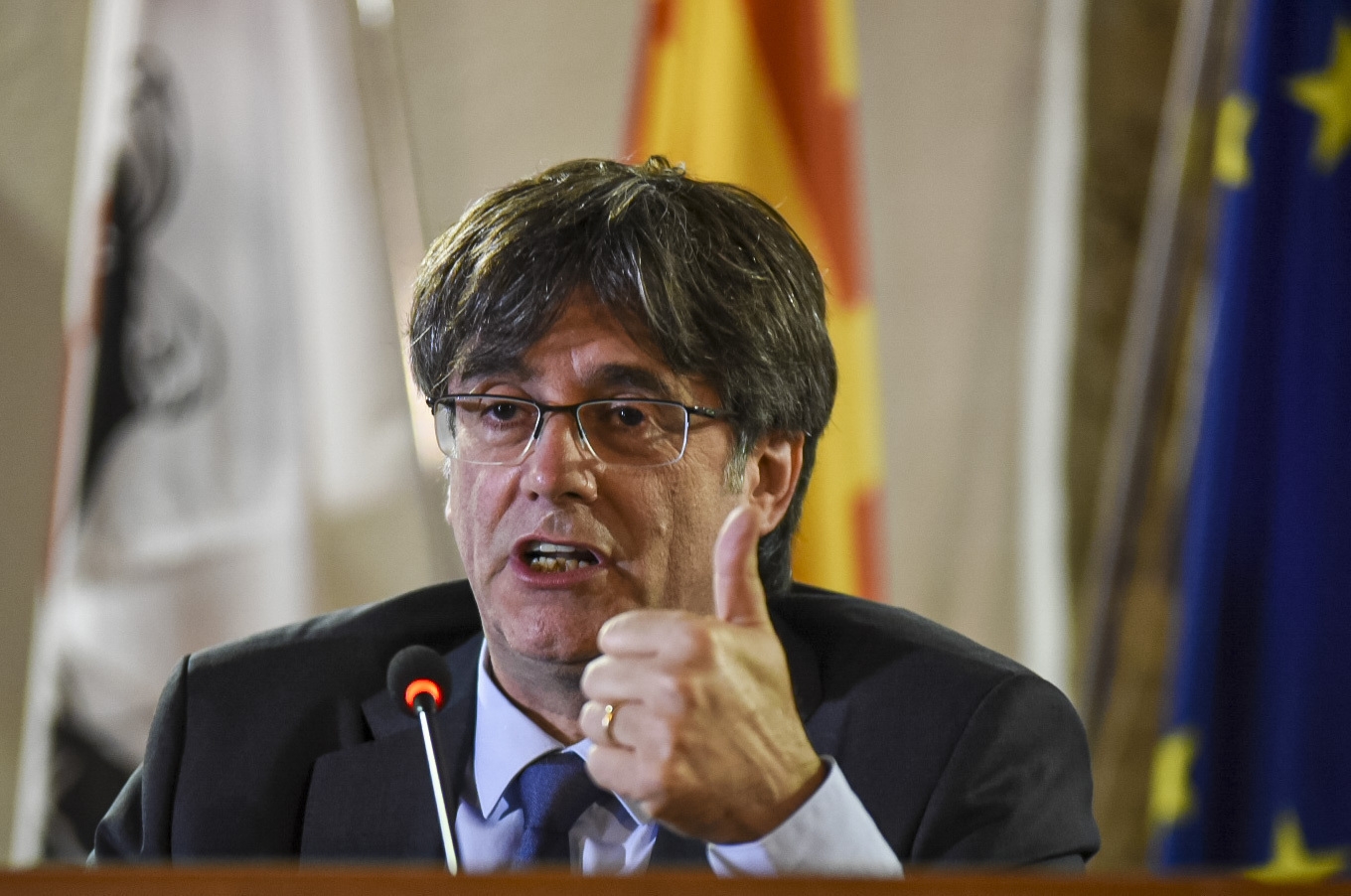 Exiled Catalan leader sets tough terms for talks on Spain's new PM