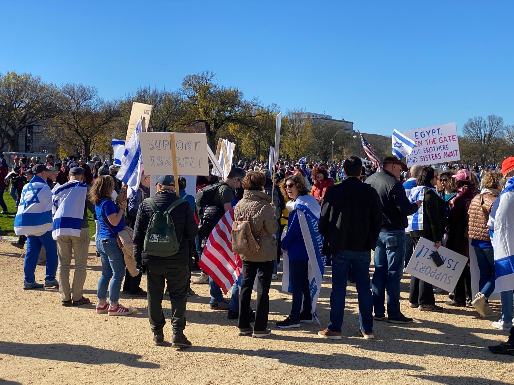Demonstrations gather with signs that say "Support Israel," some are carrying or wearing flags.