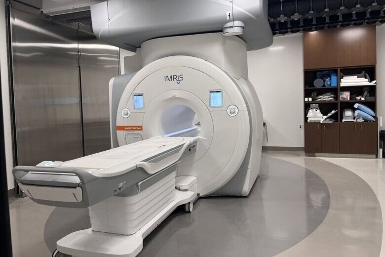 An MRI system that slides on a track between operating rooms