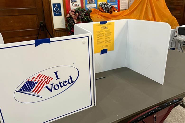 An empty voting station, adorned with an "I Voted" sign