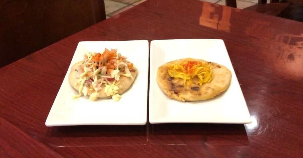 two pupusas with various toppings