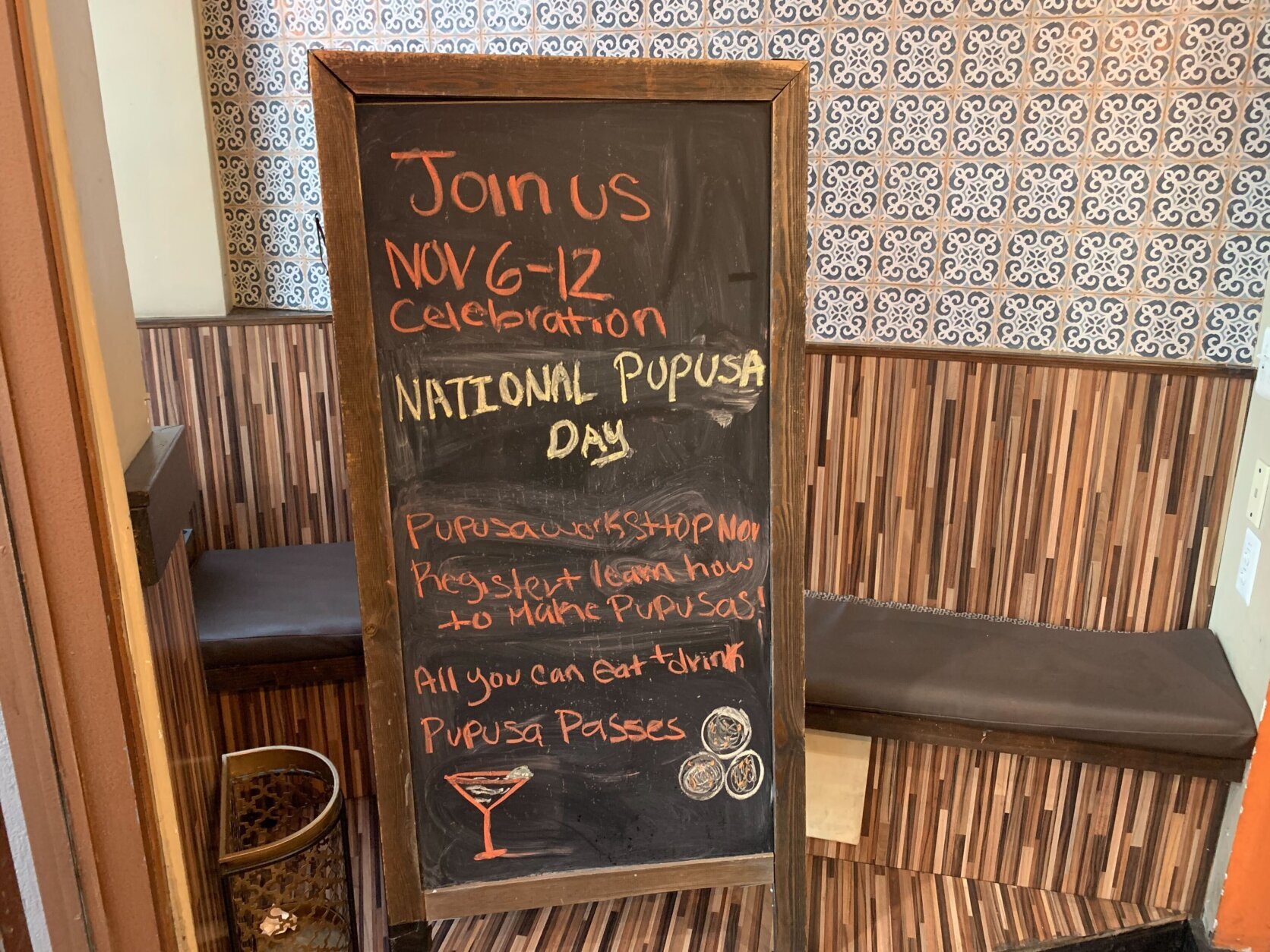 a sign shows a list of events for National Pupusa Day