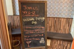 a sign shows a list of events for National Pupusa Day