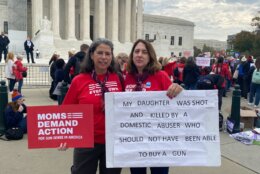 Donna Berdych of Towson, Maryland, was among those standing near the front of the rally, holding a sign that said her daughter had been shot and killed by a domestic abuser.