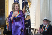 Kennedy Center honoree soprano Renée Fleming stands as she is acknowledged by President Joe Biden, together with other honorees, including Barry Gibb, right, during a reception in the East Room of the White House, Sunday, Dec. 3, 2023, in Washington. (AP Photo/Manuel Balce Ceneta)