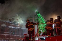 Firefighters battle a two alarm fire that started in a former fire station, Old Engine Company No. 12, now a landmark along North Capitol Street, in the Bloomingdale neighborhood of Washington, Friday, Dec. 15, 2023. (AP Photo/Andrew Harnik)