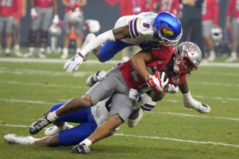 Bean throws for 6 TDs, Kansas overcomes flags to beat UNLV 49-36 in Guaranteed Rate Bowl