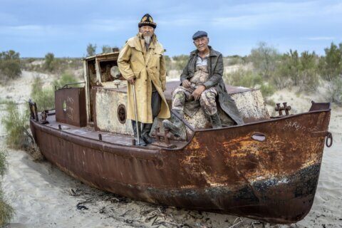 These men once relied on the Aral Sea. Today, the dry land is a reminder of lost livelihoods