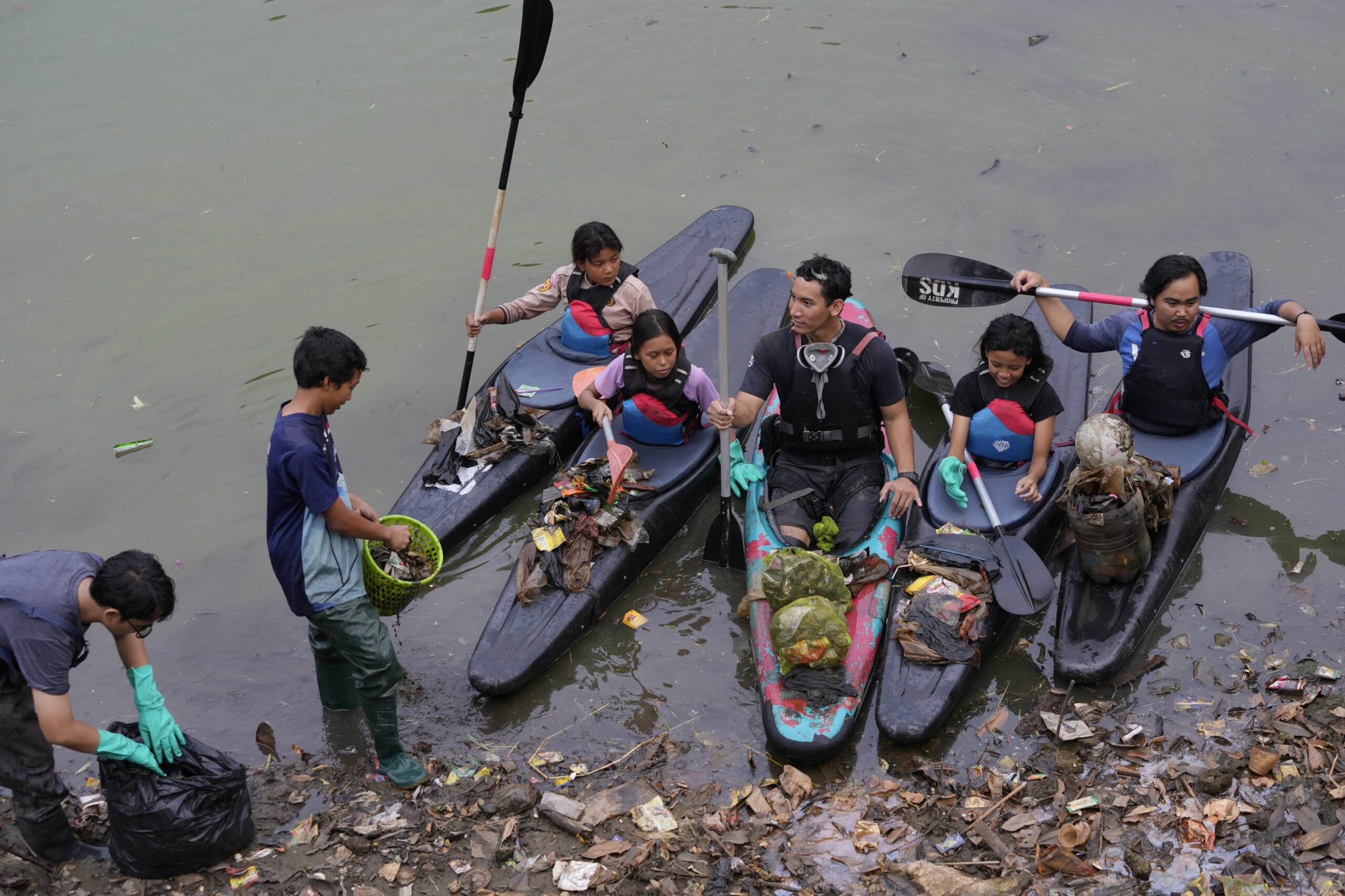 Indonesia’s youth clean up trash from waterways, but more permanent