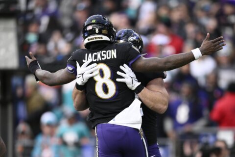 Lamar Jackson’s perfect passer rating helps Ravens rout Dolphins 56-19 to clinch top seed in AFC