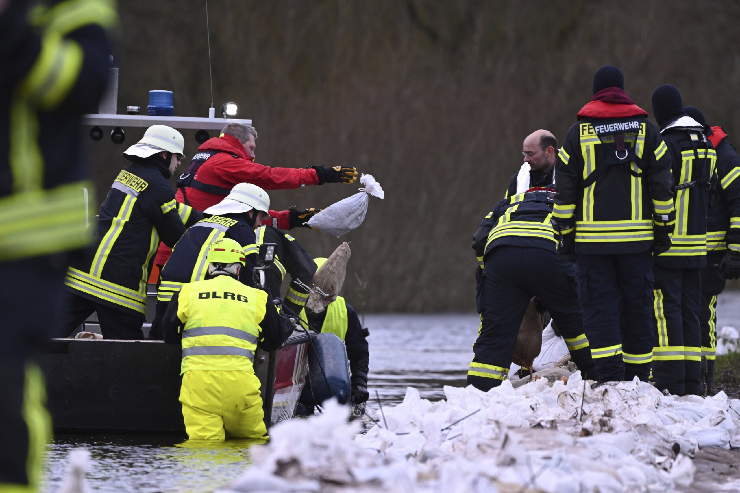 Towns reinforce dikes as heavy rains send rivers over their banks in ...