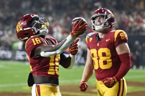 USC’s Moss throws Holiday Bowl-record 6 TD passes in 42-28 victory over No. 16 Louisville
