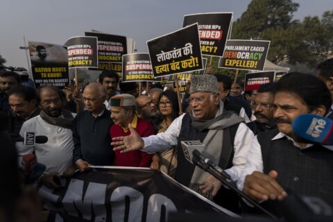 India's opposition lawmakers protest their suspension from Parliament by the government