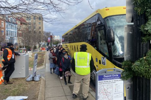 Metro riders line up for shuttle buses as maintenance begins for Red Line