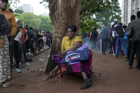 A Christmas rush to get passports to leave Zimbabwe is fed by economic gloom and a price hike