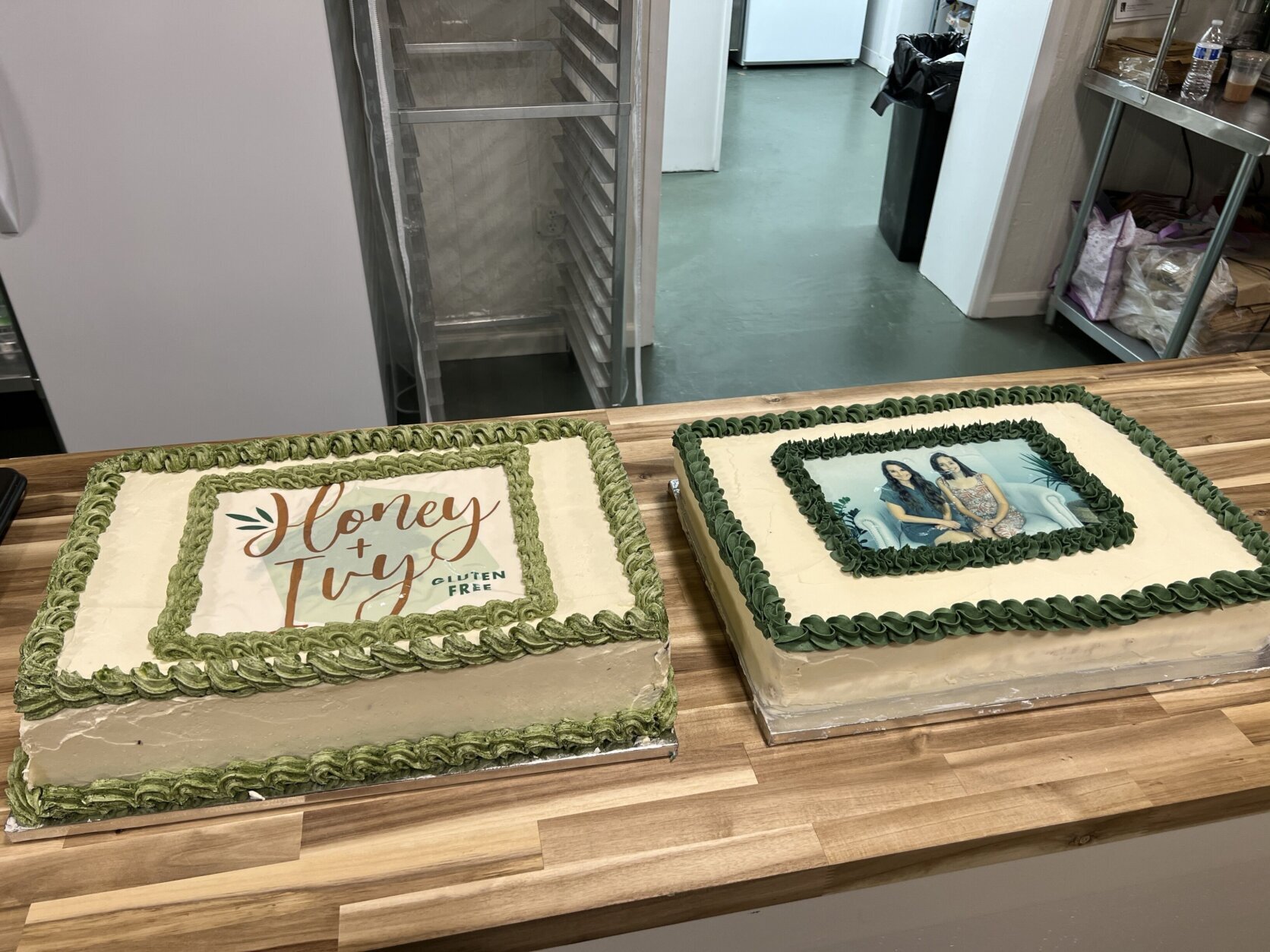 two cakes, one says "Honey and Ivy" and he other has a photo of the owners printed on top