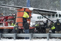 An airbag is inflated to raise the wing of Southern Airways Express flight 246, which made an emergency landing on the Loudoun County Parkway, Friday afternoon, Jan. 19, 2024, in Dulles, Va., near Washington Dulles International Airport. There were seven people on board the single-engine Cessna 208 Caravan, according to Federal Aviation Administration, and no injuries were reported. (AP Photos/Clifford Owen)