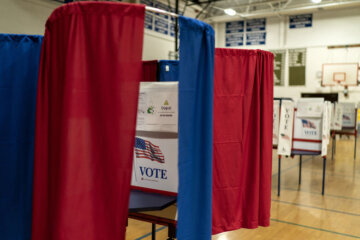 Voting booths are set up in a high school gymnasium in Hollis, N.H., Monday, Jan. 22, 2024, in preparation for tomorrow's New Hampshire Republican presidential primary. (AP Photo/David Goldman)