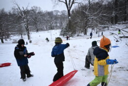 Children sled in the snow in Washington, DC, on January 16, 2024. The Washington DC metro region received between 2 and 4 inches of snow on January 15, 2024. (Photo by Brendan SMIALOWSKI / AFP) (Photo by BRENDAN SMIALOWSKI/AFP via Getty Images)
